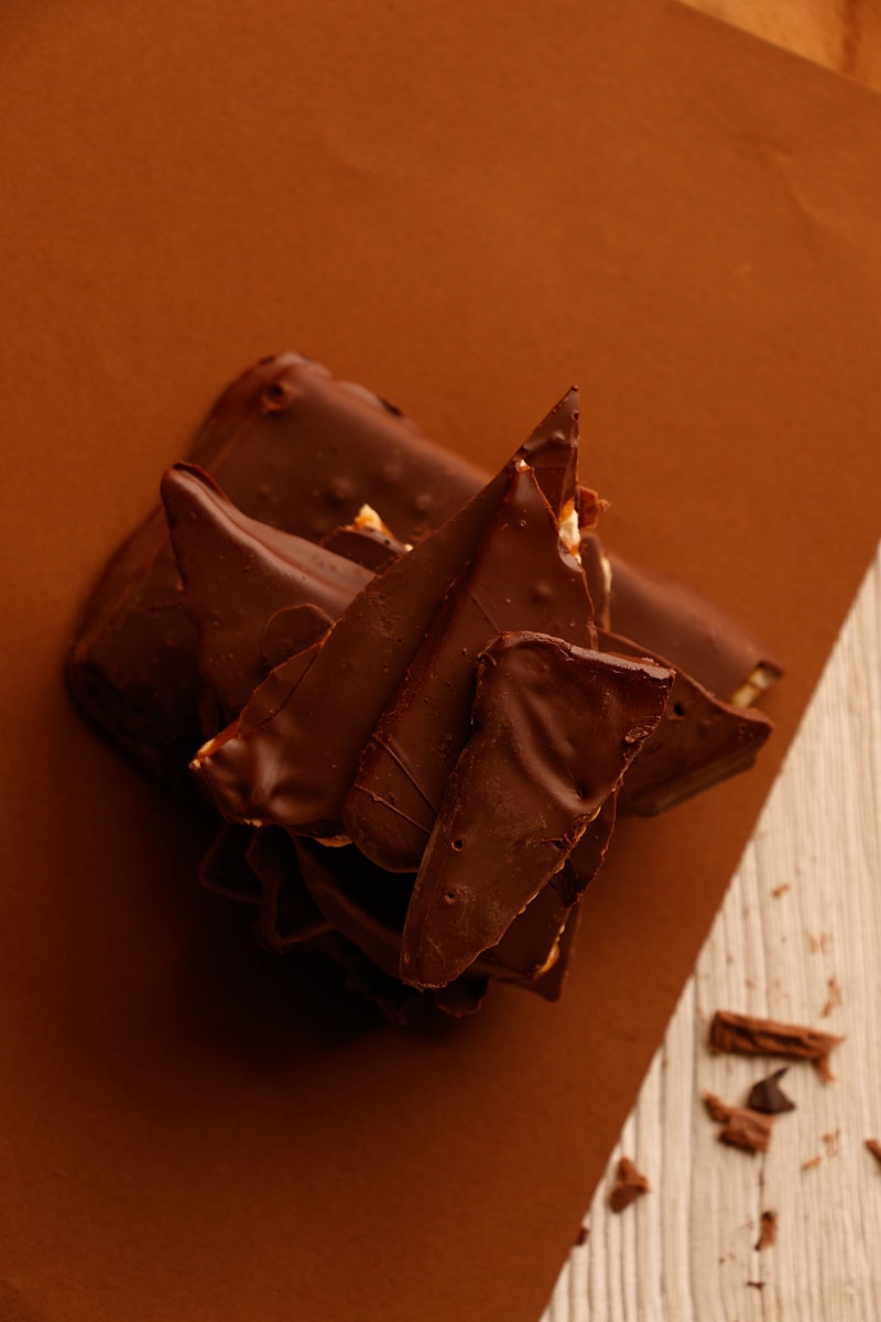 a piece of chocolate cake sitting on top of a piece of paper